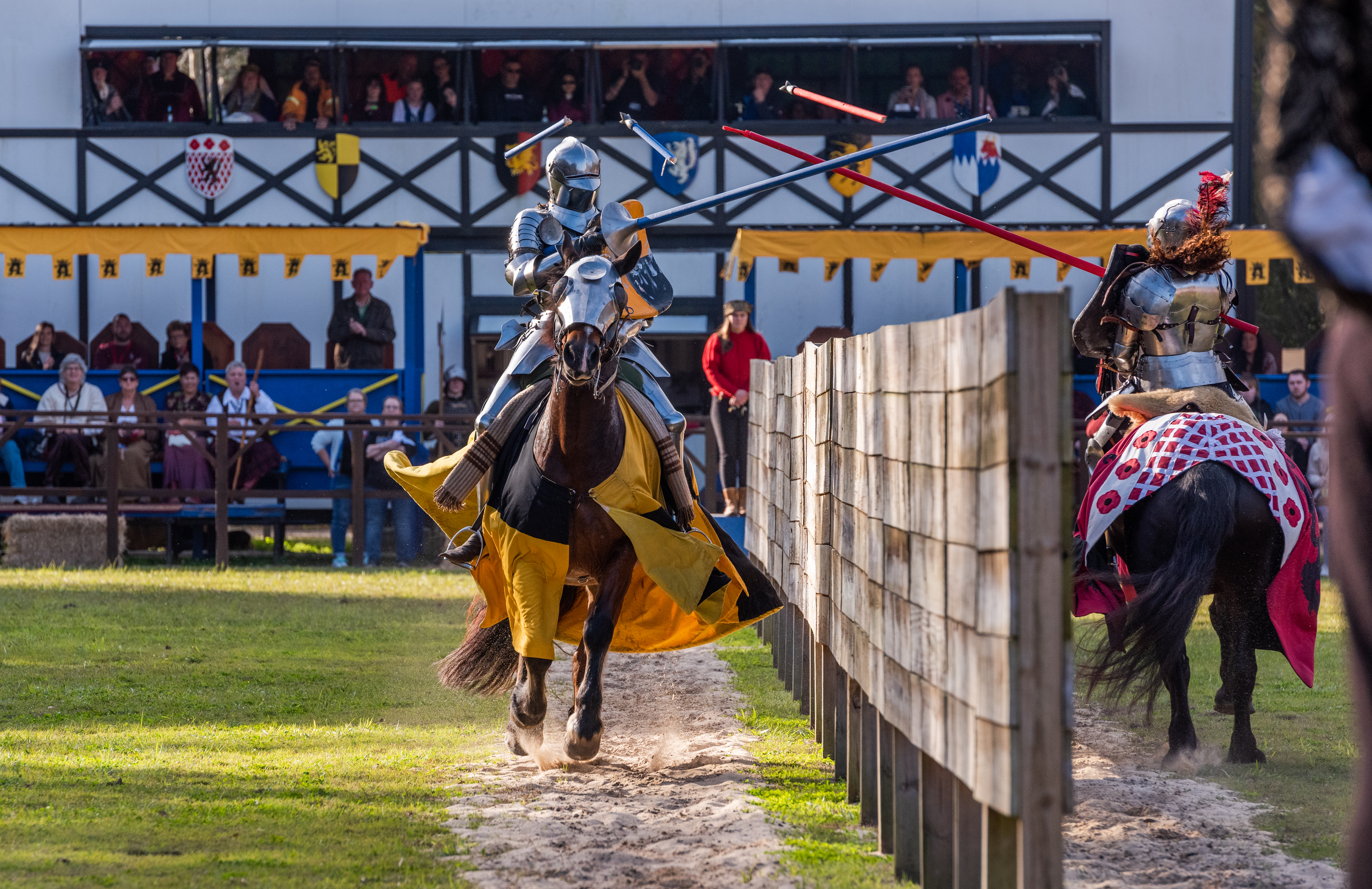 Two people on horseback joust at the Abbey Medieval Festival 